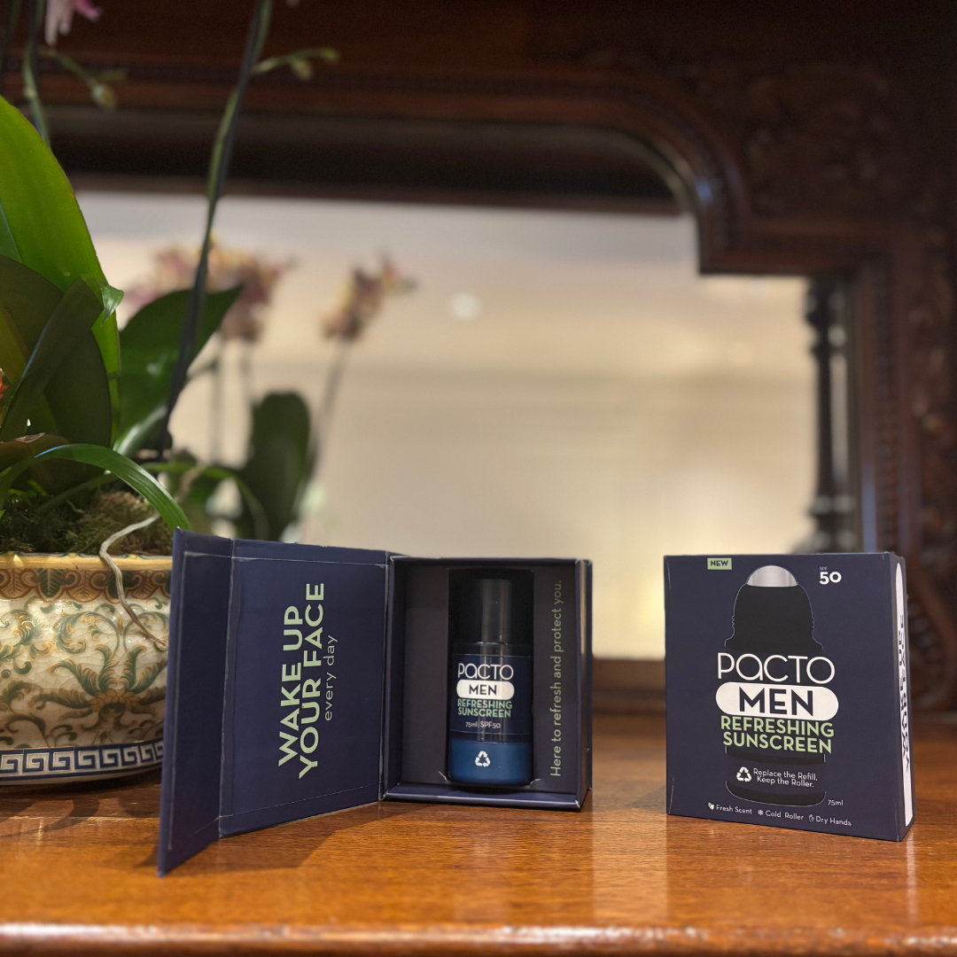 PACTO MEN refreshing sunscreen bottle and packaging on a wooden luxurious home